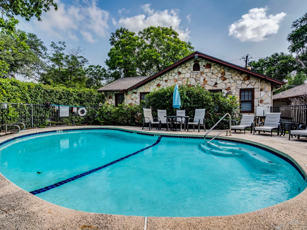3815 Menchaca Road, Unit 19 Austin, TX 78704 - Photo 13 of 14 a view of a swimming pool with chairs