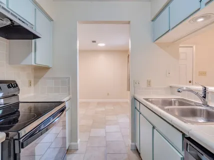 a kitchen with a sink and a refrigerator