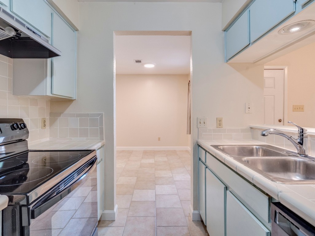 3815 Menchaca Road, Unit 19 Austin, TX 78704 - Photo 7 of 14 a kitchen with a sink and a refrigerator