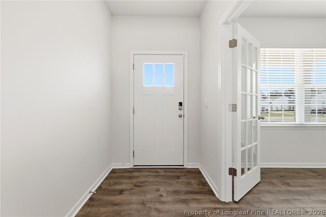 2208 Clydesmill Road Fayetteville, NC 28314 - Photo 6 of 26 a view of a hallway with white walls and a window