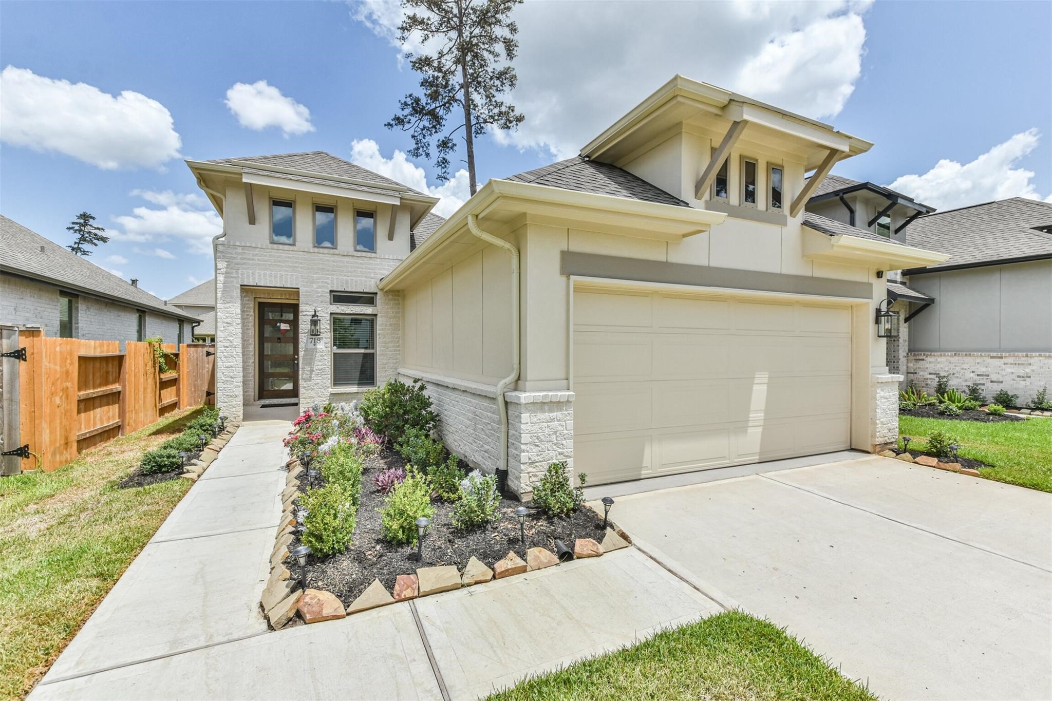 Welcome home to this beautifully designed modern retreat, featuring a charming facade, lush landscaping, and a welcoming pathway leading to your dream sanctuary.