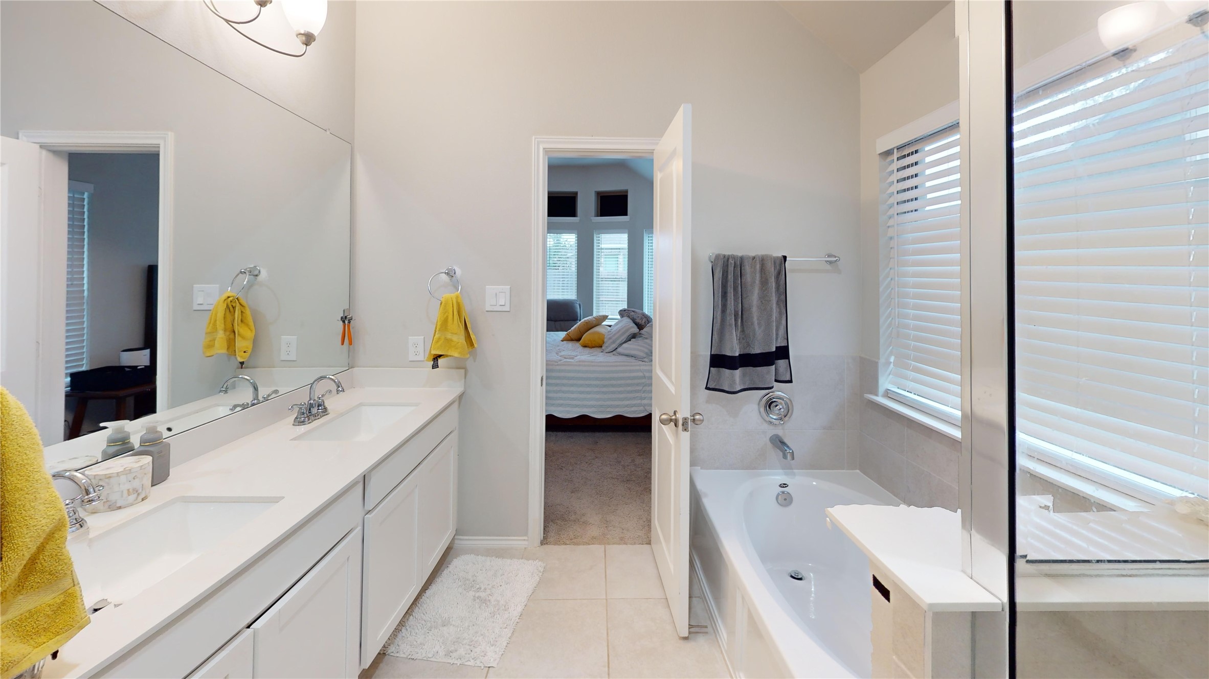 718 Santa Elena Trail Conroe, TX 77304 - Photo 14 of 29 Experience serene luxury in this primary bath, featuring a spacious double vanity, elegant soaking tub, and abundant natural light for a refreshing retreat.