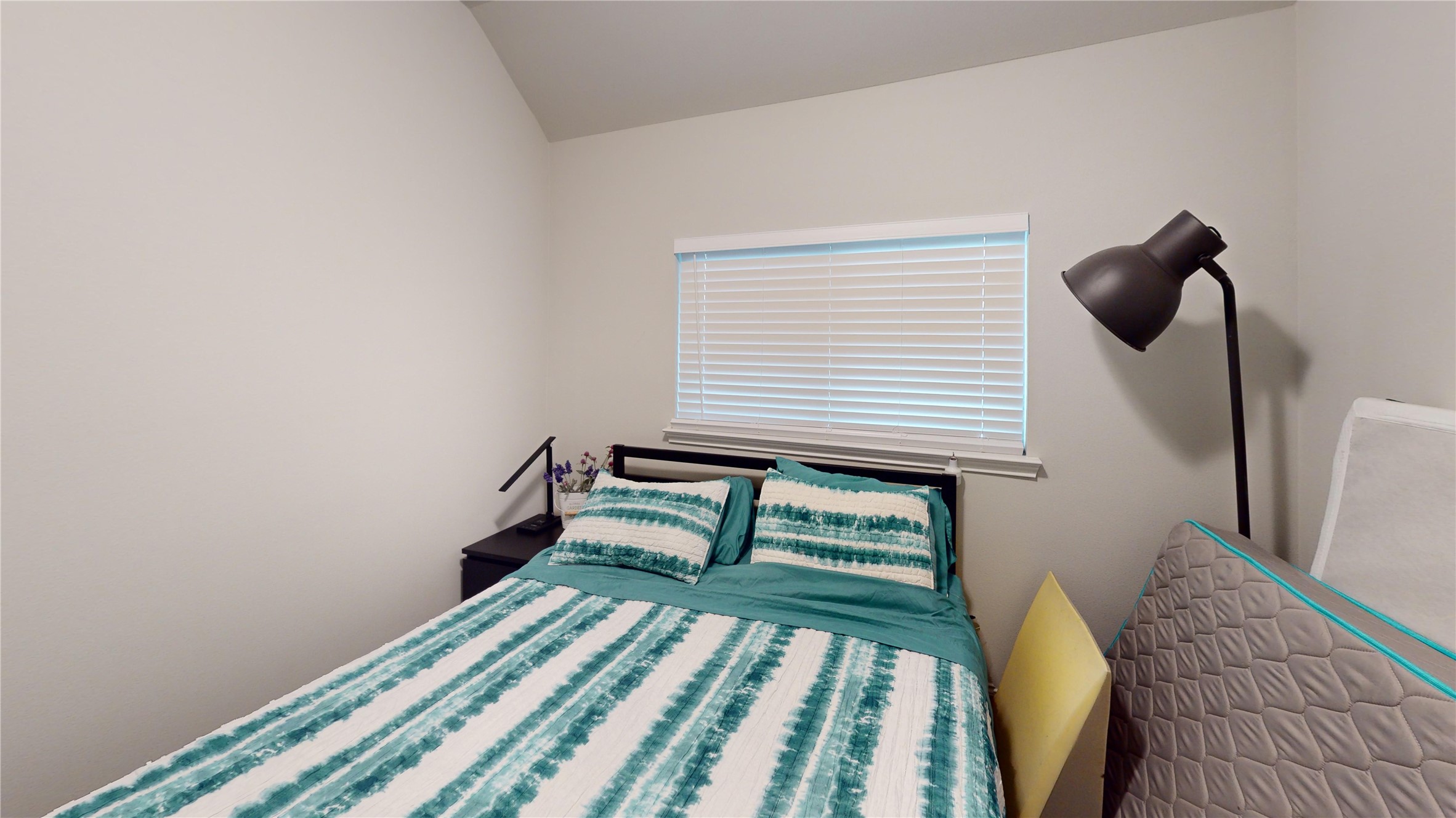 718 Santa Elena Trail Conroe, TX 77304 - Photo 16 of 29 Discover comfort in this cozy first bedroom, featuring a serene color palette and ample natural light for a restful retreat.