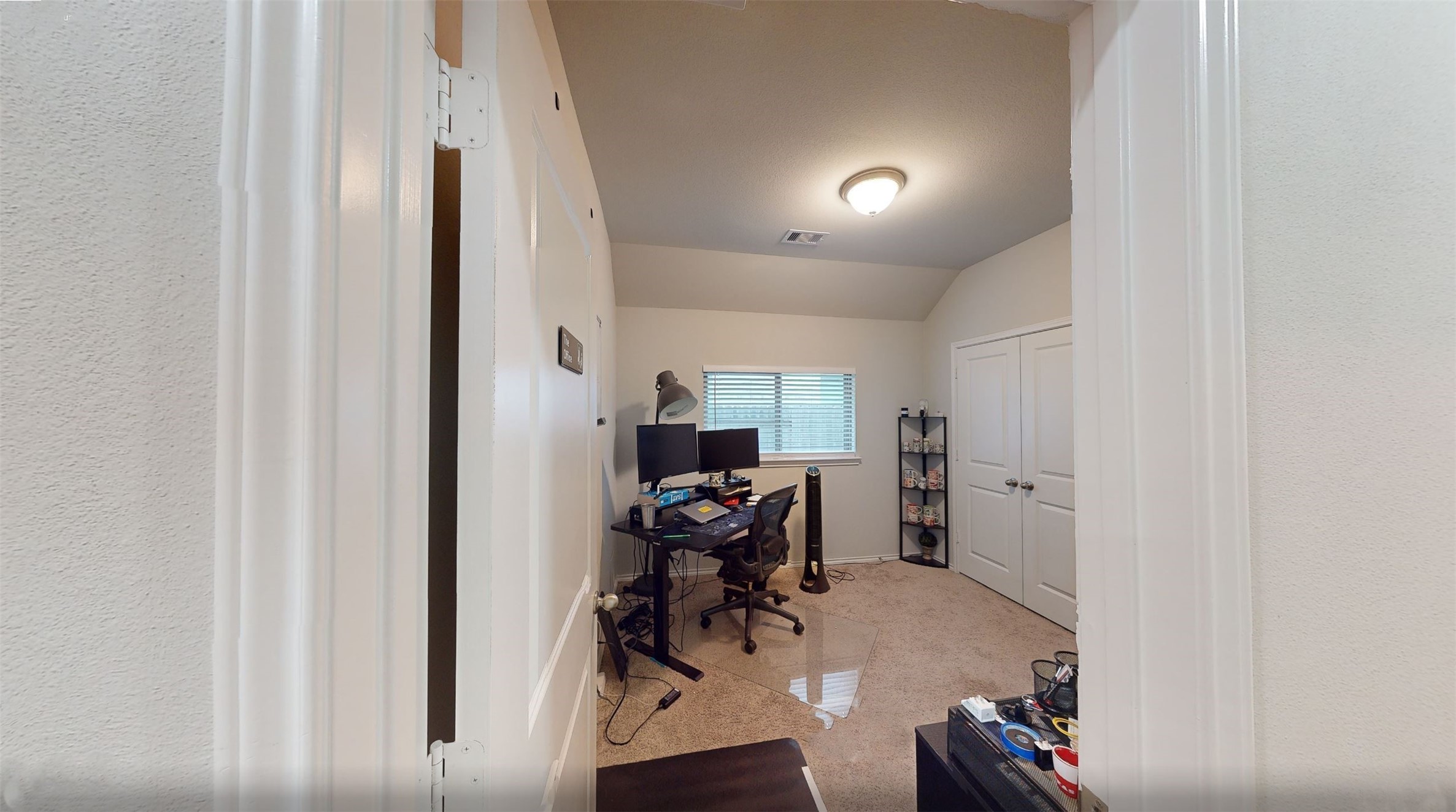 718 Santa Elena Trail Conroe, TX 77304 - Photo 18 of 29 This inviting second bedroom offers a cozy space with soft carpeting, a built-in closet for ample storage, and a large window that fills the room with natural light, perfect for a guest room or a productive home office.