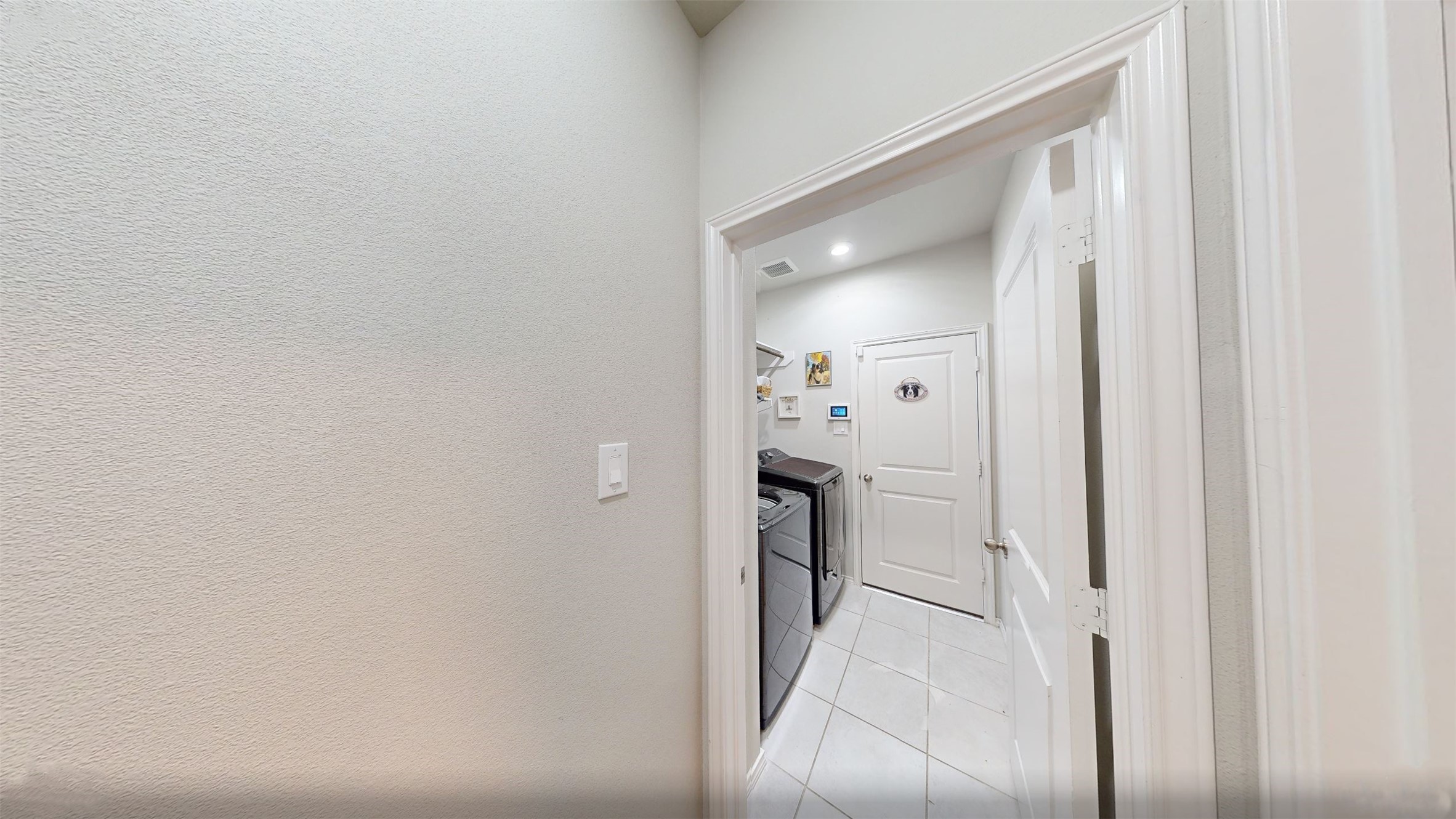 718 Santa Elena Trail Conroe, TX 77304 - Photo 19 of 29 Discover convenience with a stylish hallway leading directly to a modern, well-equipped laundry room.