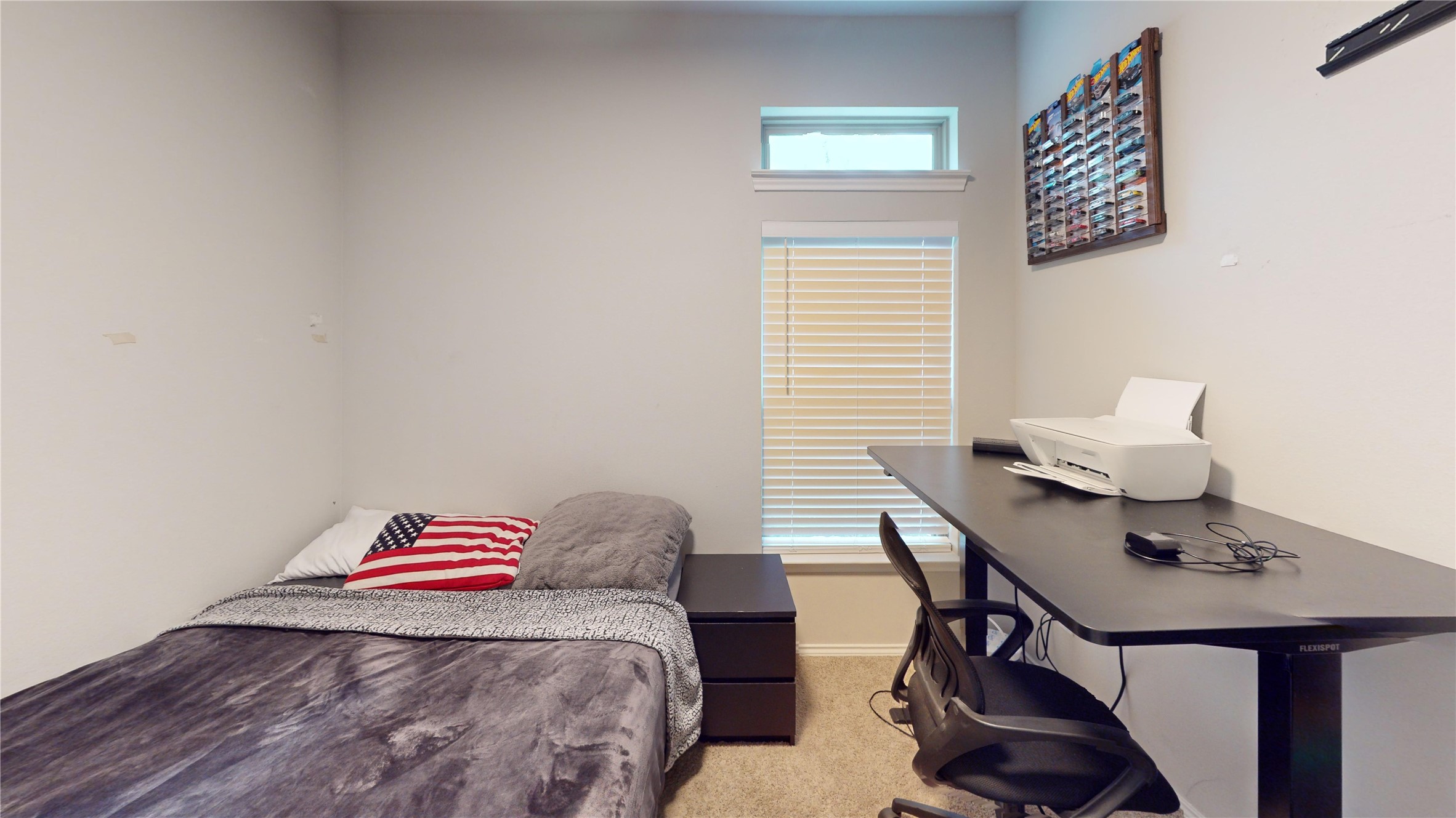 718 Santa Elena Trail Conroe, TX 77304 - Photo 21 of 29 Discover versatility in this cozy third bedroom, perfect for relaxation or productivity, featuring ample natural light and a functional workspace.