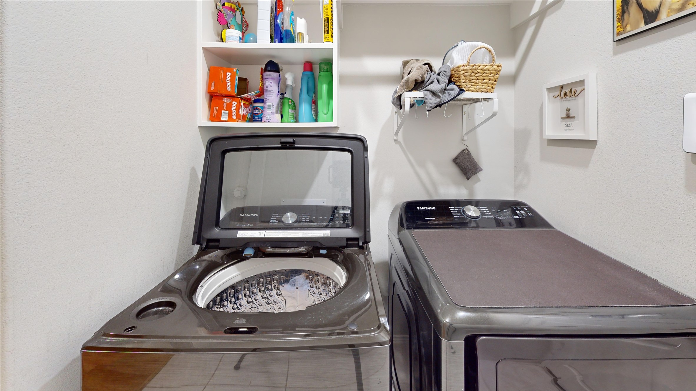 718 Santa Elena Trail Conroe, TX 77304 - Photo 22 of 29 This modern laundry room combines efficiency and style with sleek appliances, ample shelving for organization, and a cozy ambiance, making laundry days a breeze.