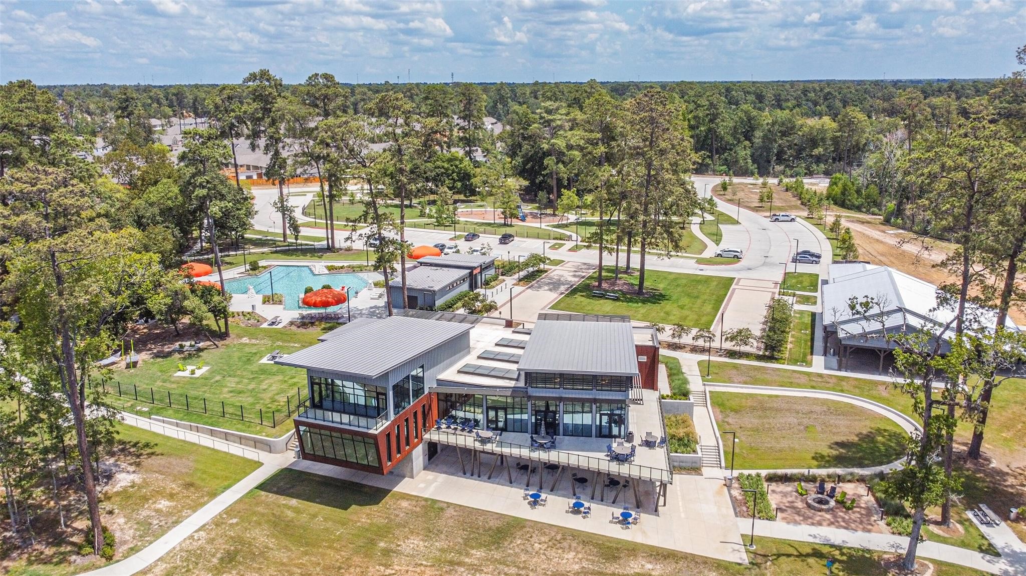718 Santa Elena Trail Conroe, TX 77304 - Photo 27 of 29 Discover a vibrant community hub featuring a sleek clubhouse, refreshing pool, and inviting outdoor spaces, all nestled amidst lush greenery for the perfect blend of relaxation and recreation.