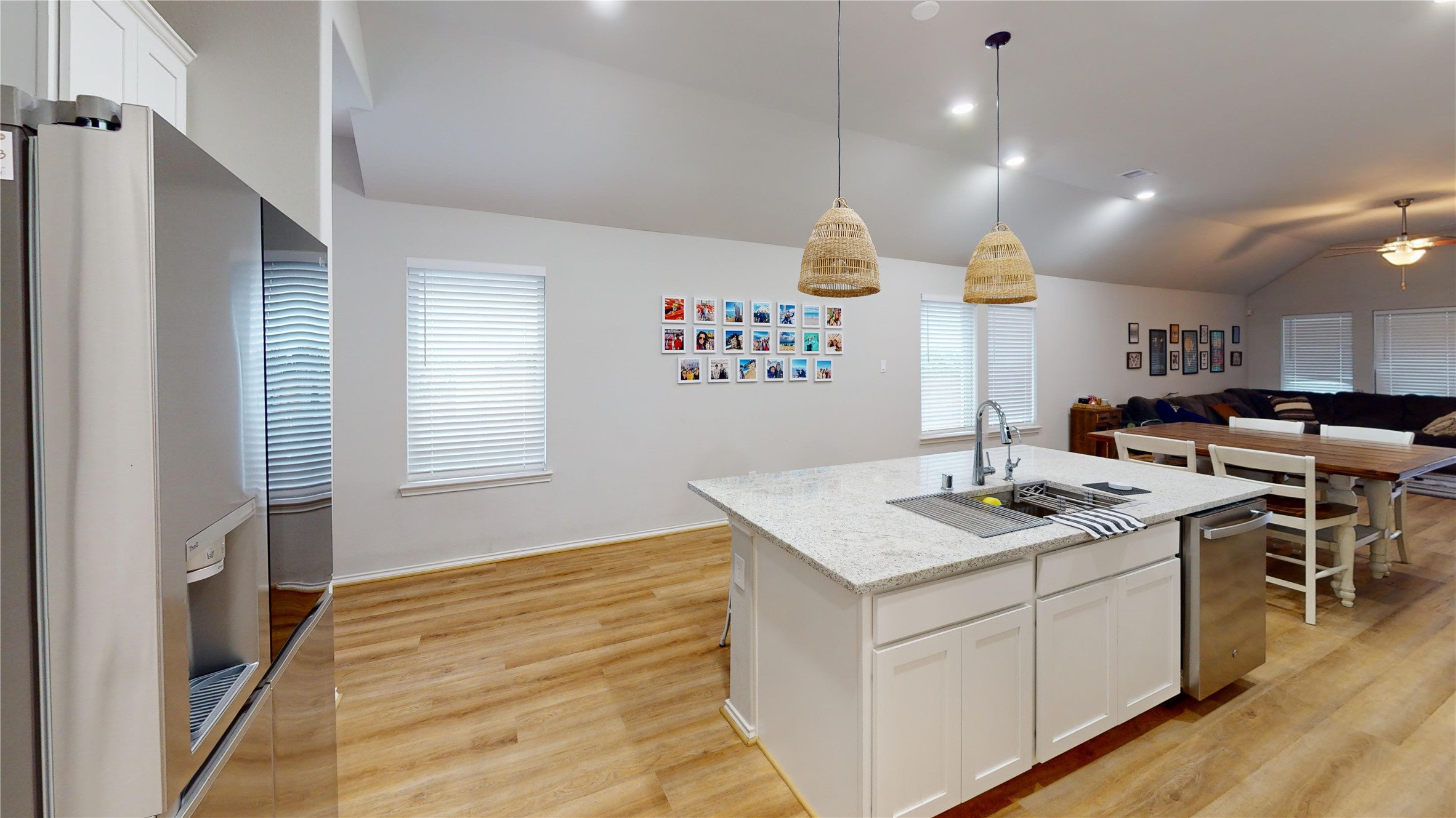 718 Santa Elena Trail Conroe, TX 77304 - Photo 4 of 29 This inviting kitchen boasts a spacious island with sleek granite countertops, modern pendant lighting, and an open layout that seamlessly connects to the cozy living area, perfect for both entertaining and everyday family life.