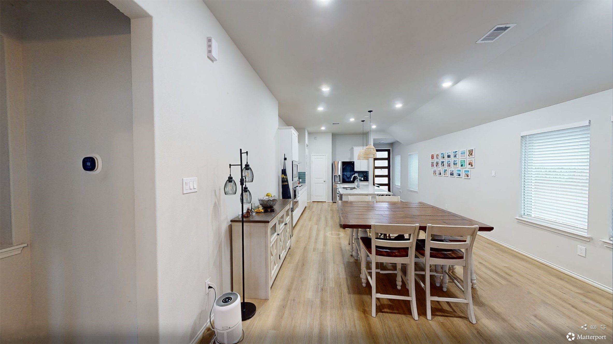 718 Santa Elena Trail Conroe, TX 77304 - Photo 8 of 29 A bright and inviting dining room with sleek hardwood floors and contemporary lighting, seamlessly connected to the kitchen for perfect entertaining flow.