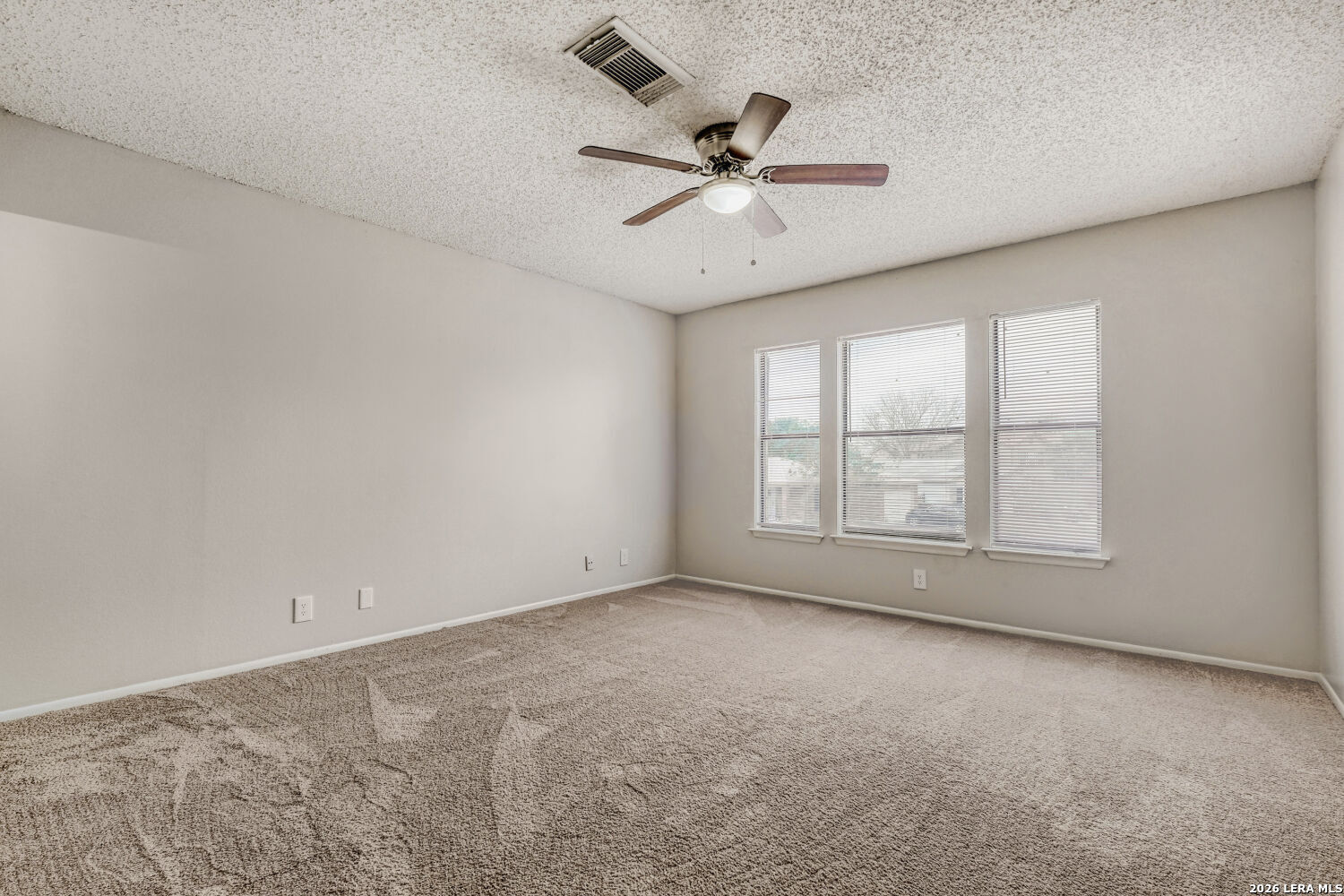8264 Longhorn Ridge Drive Converse, TX 78109 - Photo 11 of 17 an empty room with a window and a fan