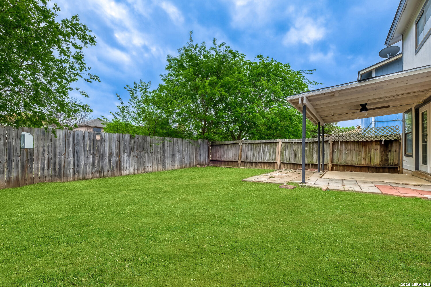 8264 Longhorn Ridge Drive Converse, TX 78109 - Photo 16 of 17 a view of a backyard with a small cabin and wooden fence