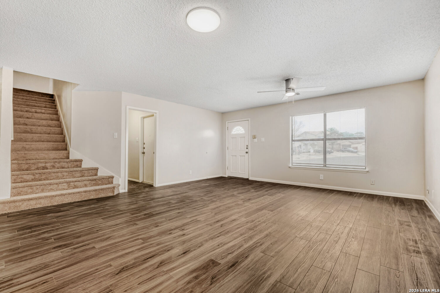 8264 Longhorn Ridge Drive Converse, TX 78109 - Photo 3 of 17 an empty room with wooden floor and windows