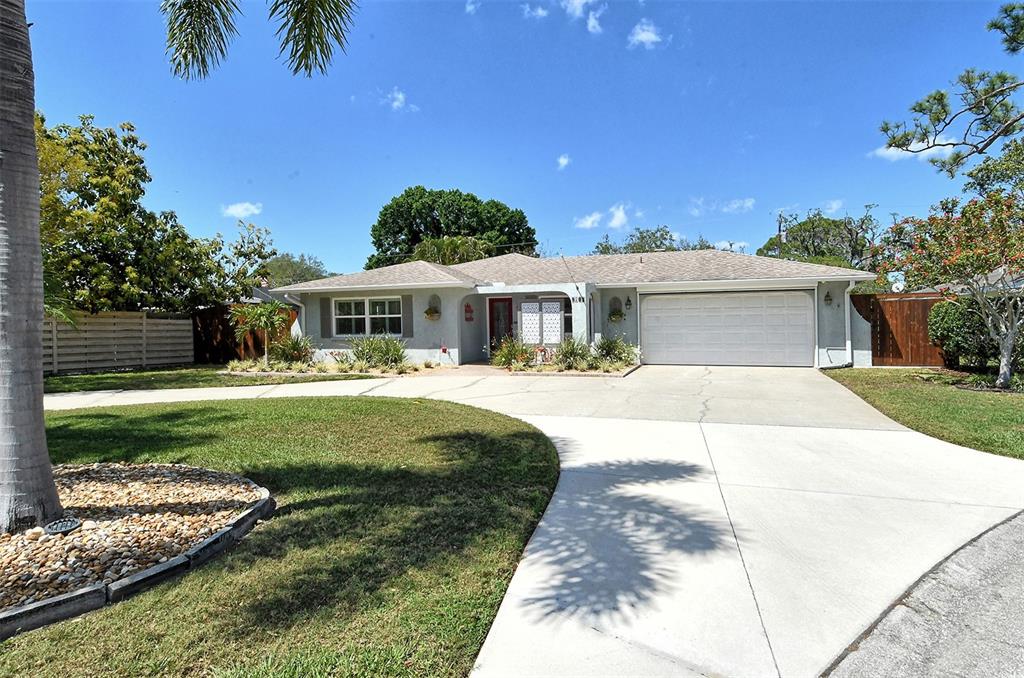 5105 Medalist Road Sarasota, FL 34243 - Photo 1 of 1 a view of a white house with a yard table and chairs