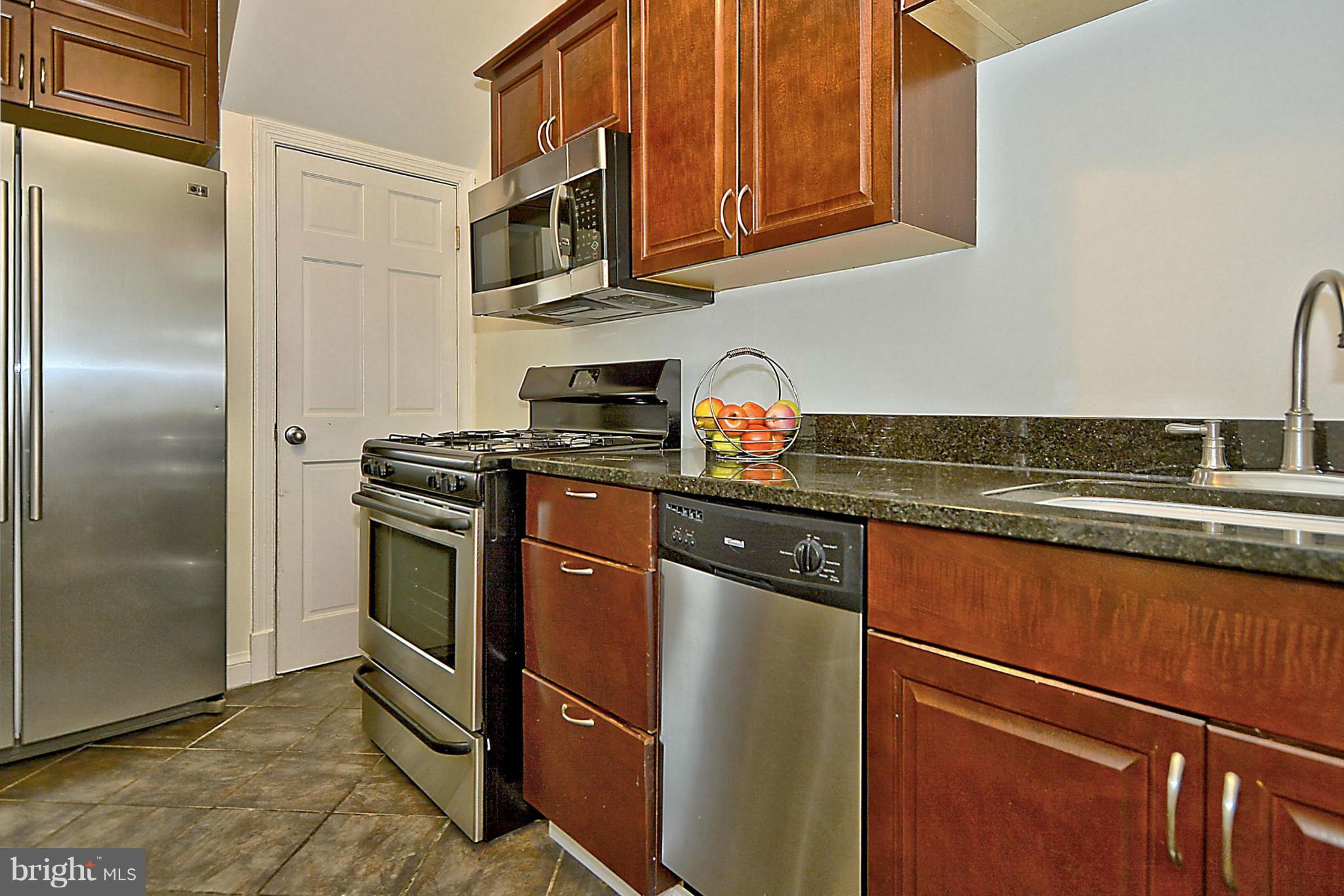 200 South Courthouse Road Arlington, VA 22204 - Photo 8 of 30 a kitchen with stainless steel appliances granite countertop a refrigerator a stove and a sink