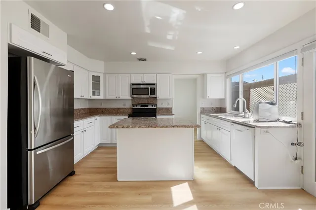 a kitchen with a refrigerator stove and microwave