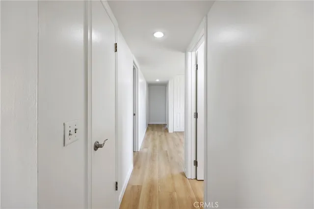 a view of empty room with wooden floor