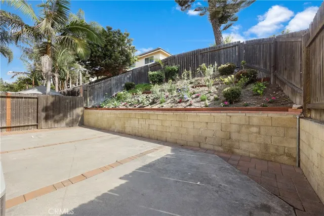 a view of a patio with a table chairs and a fire pit