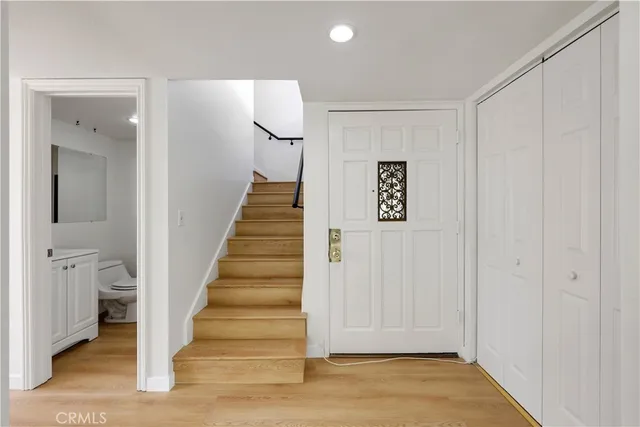 a view of entryway with wooden floor and workspace