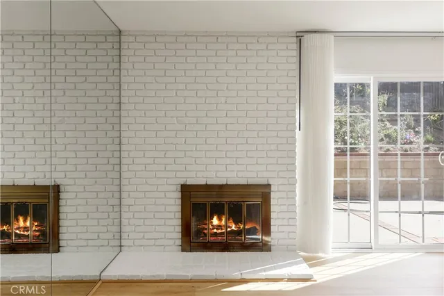 an empty room with windows and ceiling fan