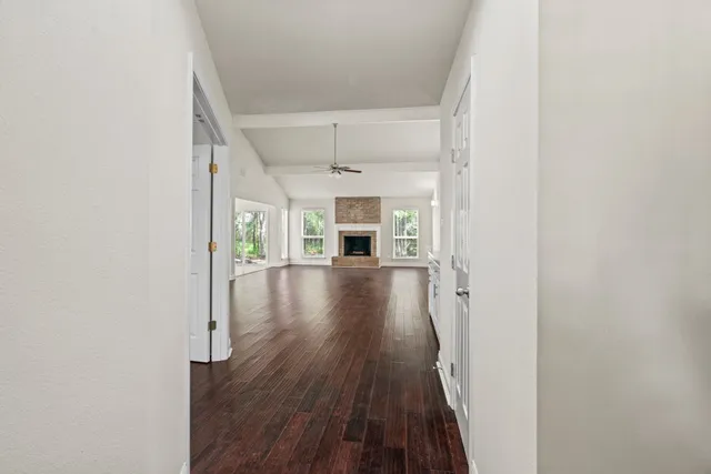 wooden floor in an empty room with a window