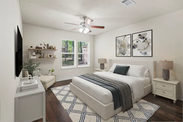 a bedroom with a large bed and a chandelier
