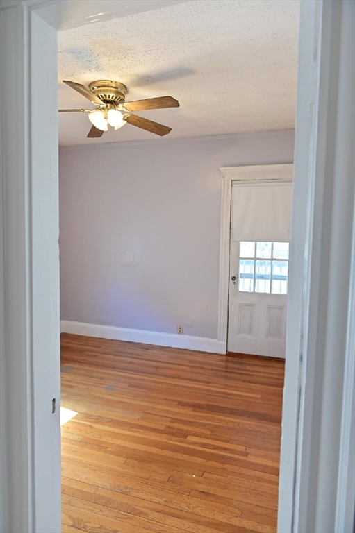 90 Elmer Road, Unit 2 Boston, MA 02124 - Photo 6 of 12 a view of an empty room with wooden floor and a window