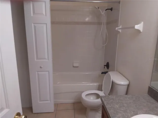 a bathroom with a granite countertop sink a mirror and a shower