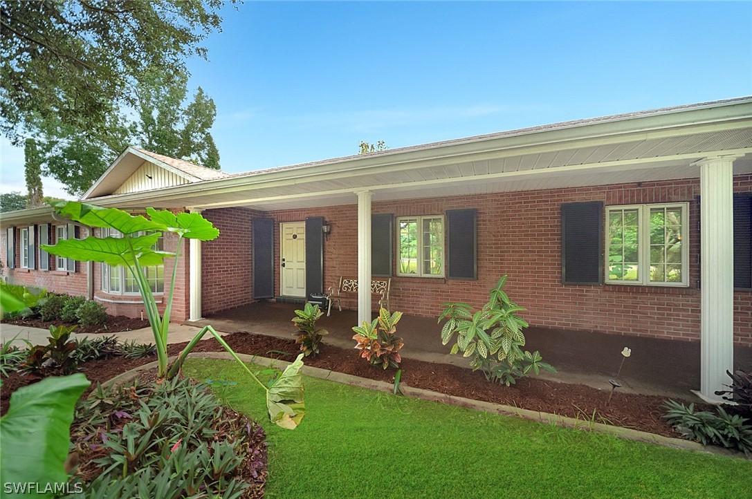 a view of house with backyard space and garden