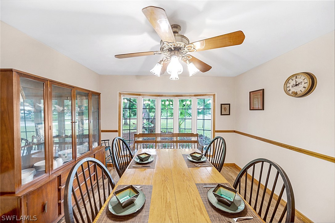 10244 Horizon Drive Spring Hill, FL 34608 - Photo 13 of 35 a view of a dining room with furniture wooden floor and chandelier