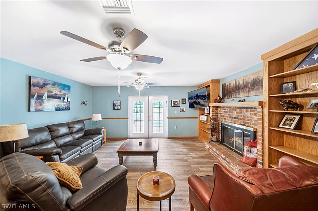 10244 Horizon Drive Spring Hill, FL 34608 - Photo 15 of 35 a living room with furniture a rug and a bookshelf
