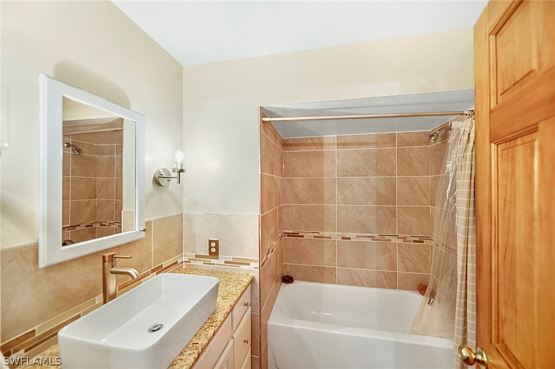 10244 Horizon Drive Spring Hill, FL 34608 - Photo 24 of 35 a bathroom with a bathtub a sink a window and a shower