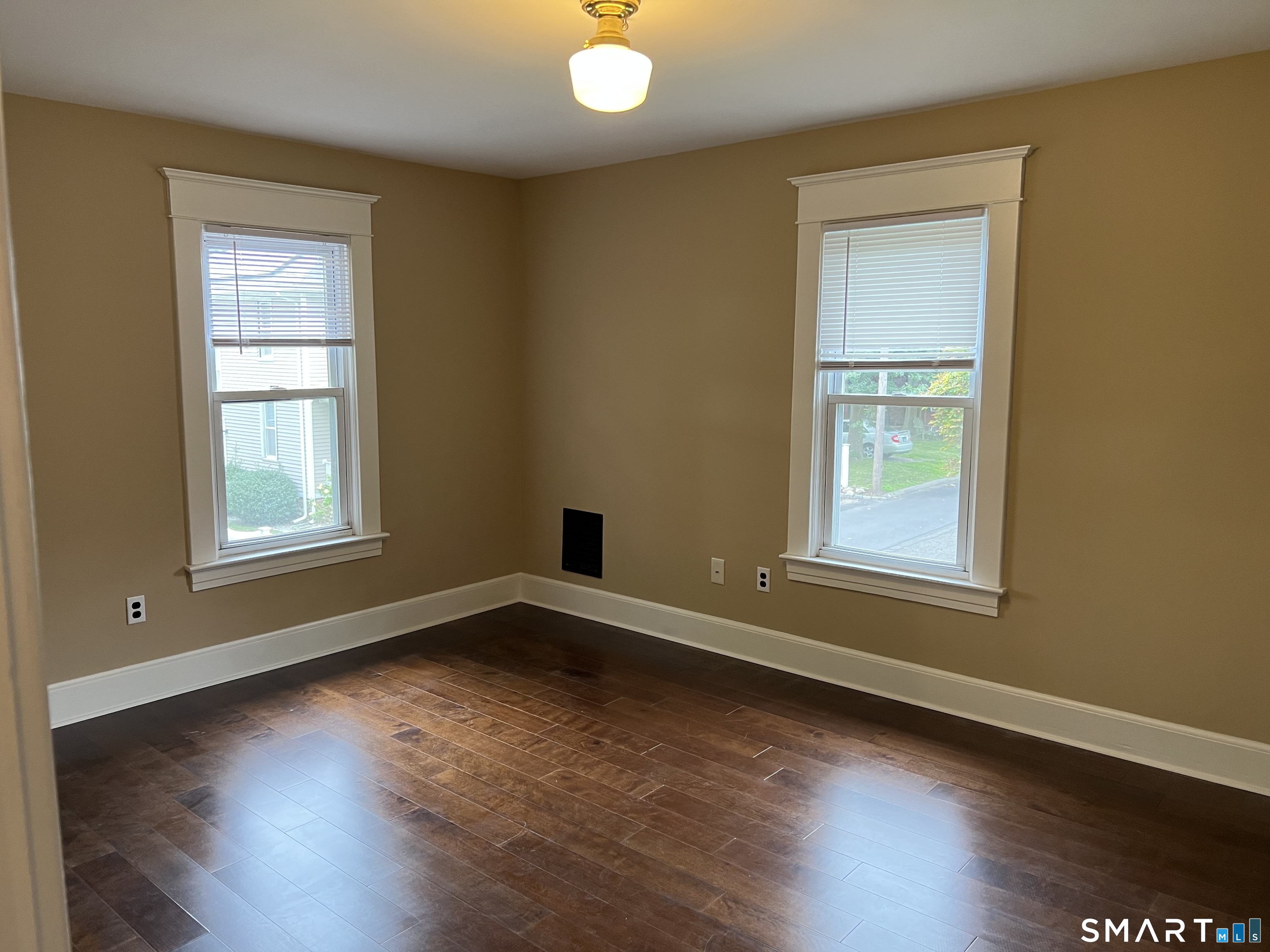 16 Cowing Terrace Stamford, CT 06906 - Photo 12 of 24 an empty room with wooden floor and windows