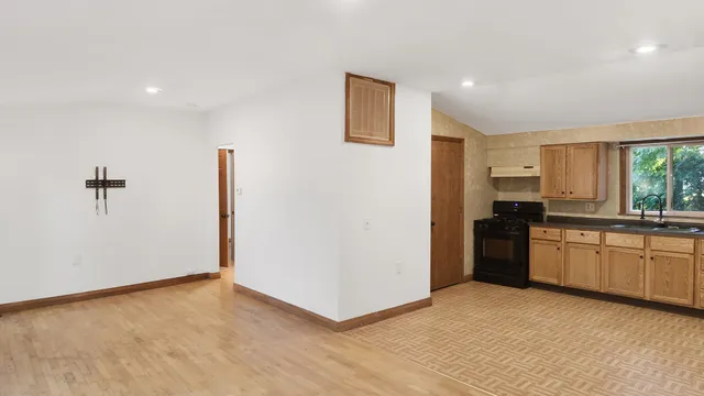 a kitchen with a refrigerator and a stove top oven
