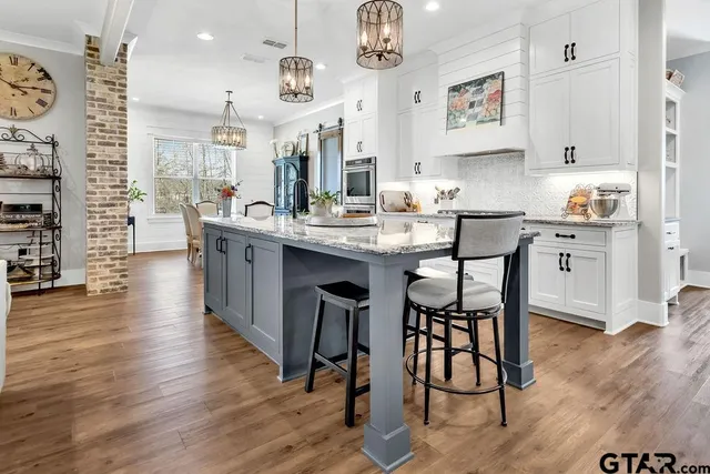 a kitchen with kitchen island granite countertop lots of counter top space and furniture