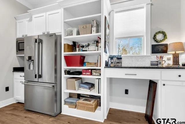 a kitchen with stainless steel appliances granite countertop a sink and cabinets