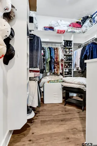 a bathroom with a granite countertop sink mirror and bathtub