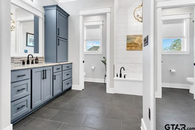 a spacious bathroom with a double vanity sink double and mirror