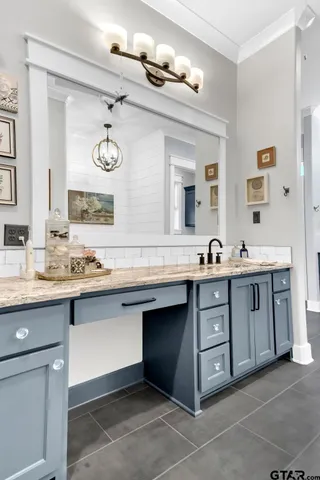 a bathroom with a tub sink and mirror