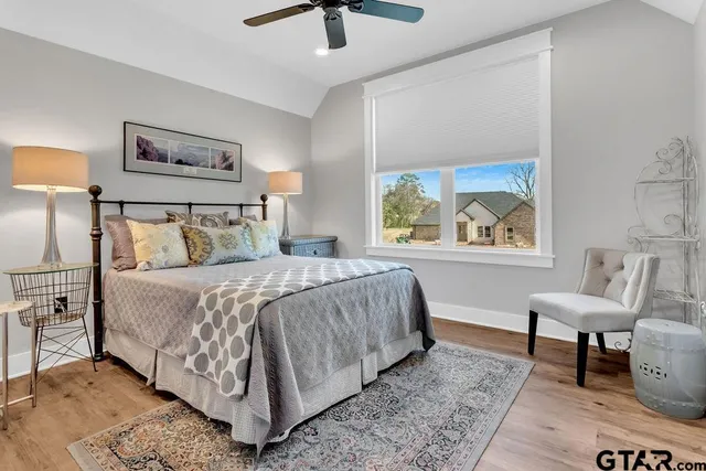 a bed sitting in a bedroom next to a window
