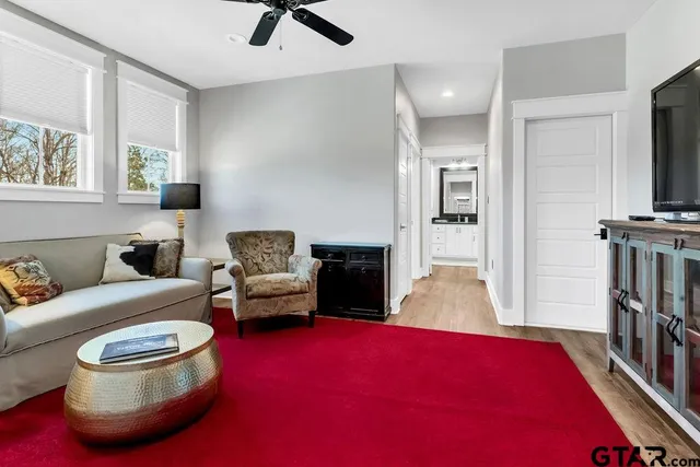 a bathroom with a granite countertop toilet sink and mirror