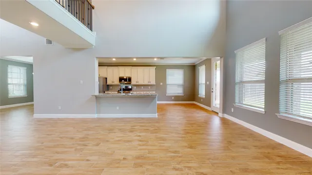 a view of an empty room with a ceiling fan and a window
