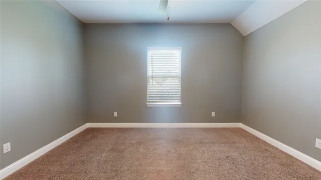 an empty room with closet and a chandelier fan