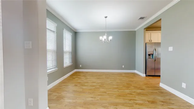 a view of a big room with wooden floor and staircase