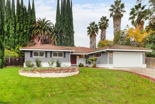 a front view of a house with a garden