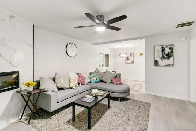 a living room with furniture and a fireplace