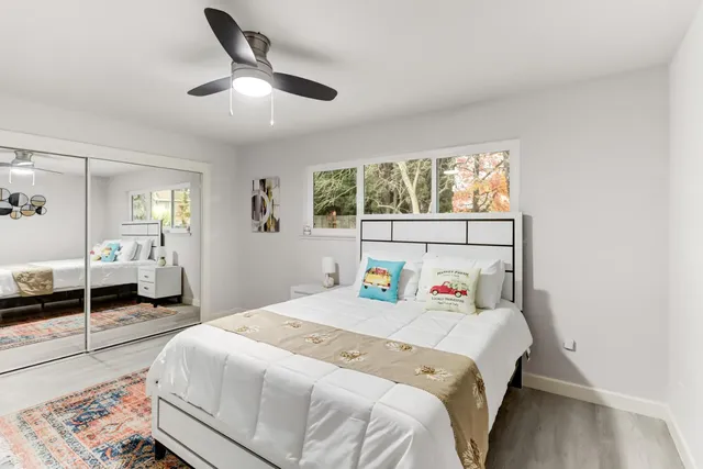 a bedroom with a large bed and a chandelier