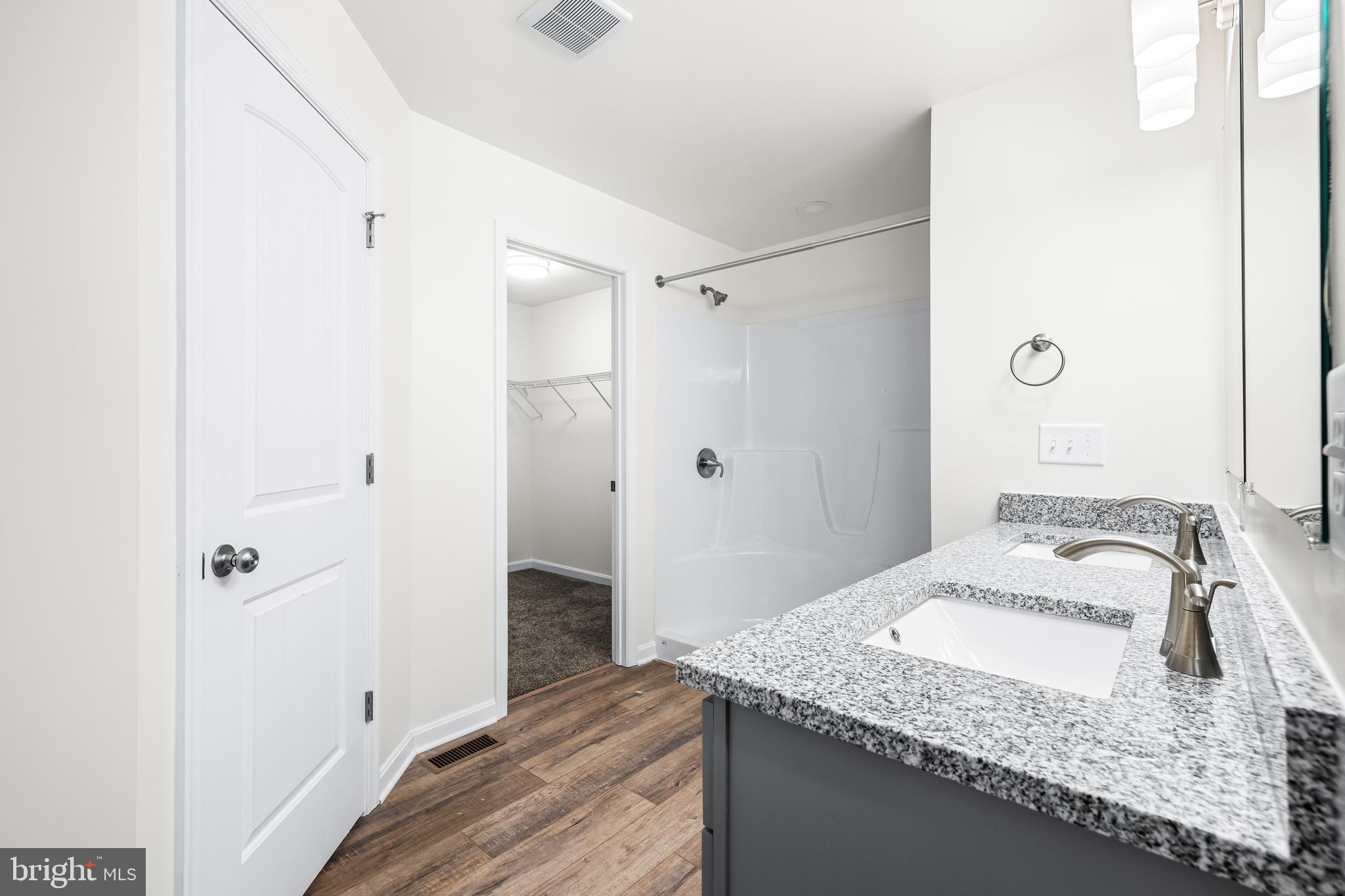 900 Gilbert Road, Unit 3622B Aberdeen, MD 21001 - Photo 12 of 22 a bathroom with a granite countertop sink and a mirror