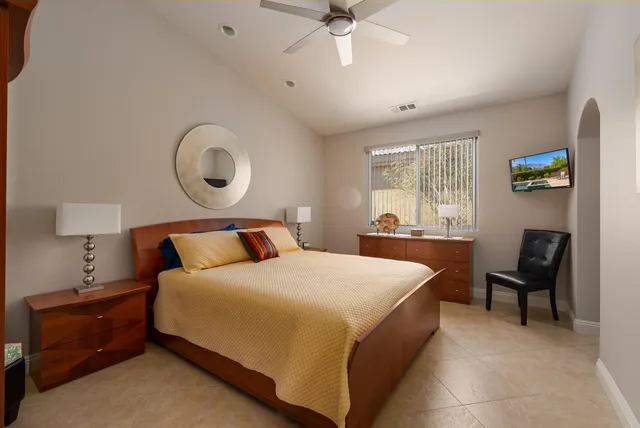 a bedroom with a bed and a television