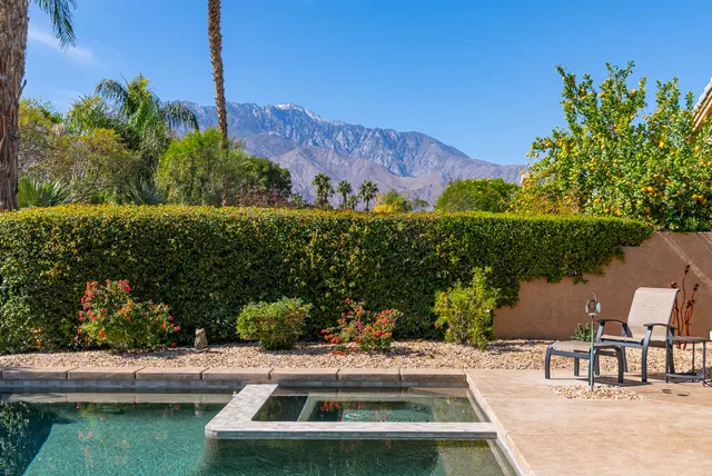 a view of a house with swimming pool and sitting area